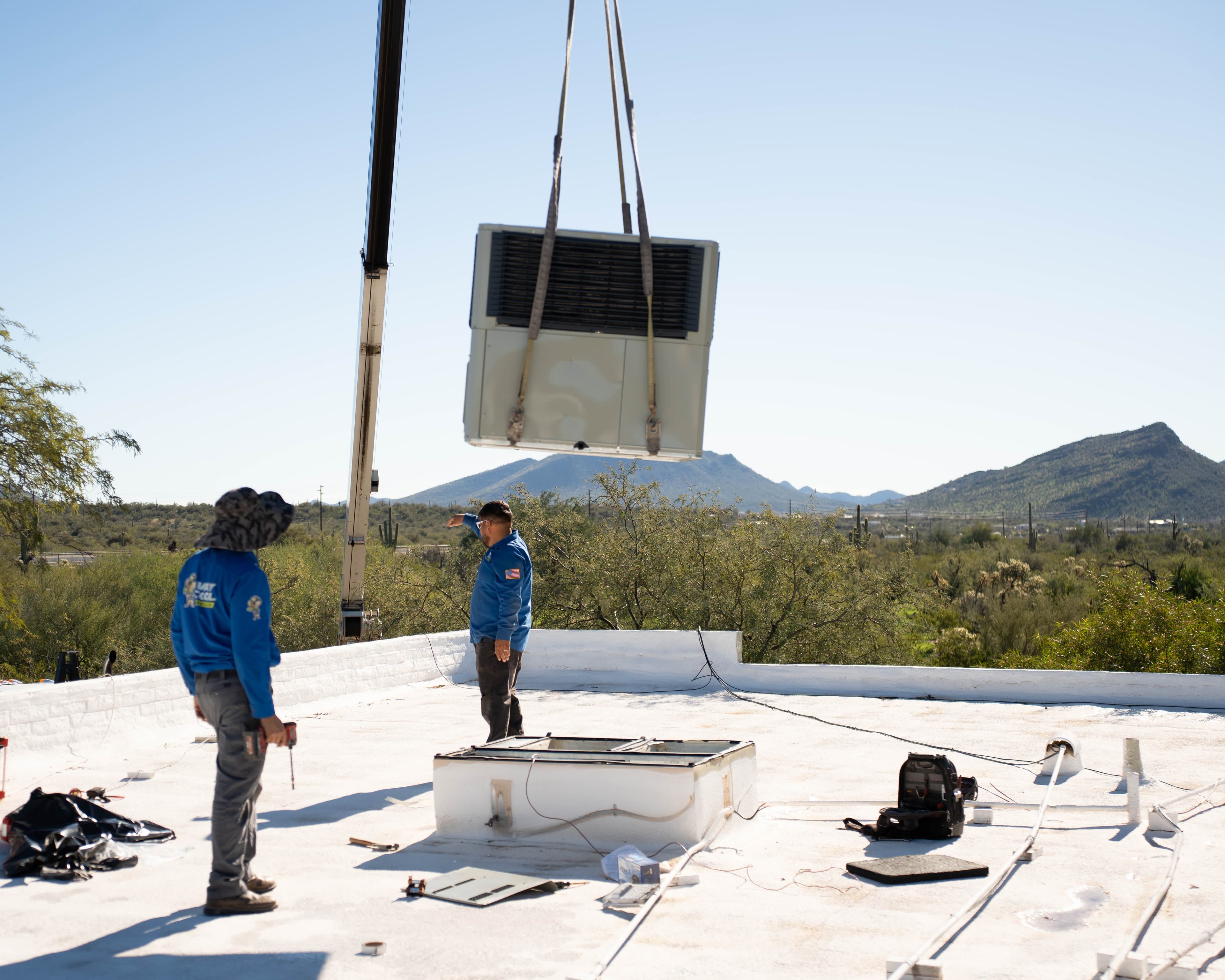 Crane lifting a rooftop package unit